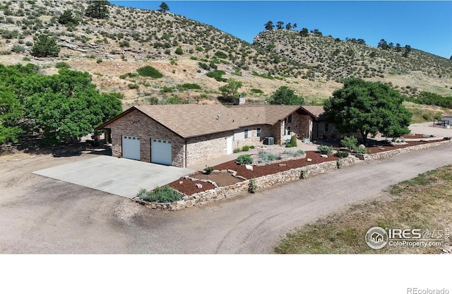 exterior space with a garage and a mountain view