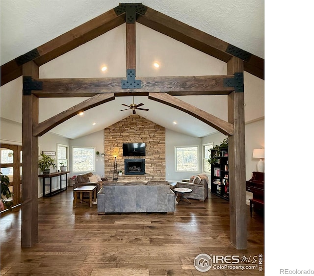 living room with ceiling fan, dark wood-type flooring, plenty of natural light, and beam ceiling