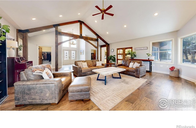 living room with lofted ceiling, ceiling fan, french doors, and hardwood / wood-style floors