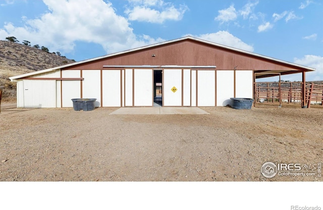 rear view of property with an outbuilding