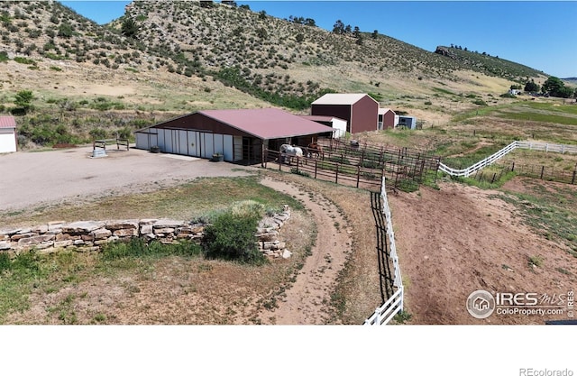 drone / aerial view featuring a rural view and a mountain view