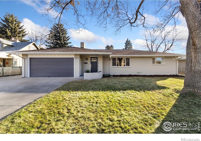 ranch-style house featuring a front lawn and a garage