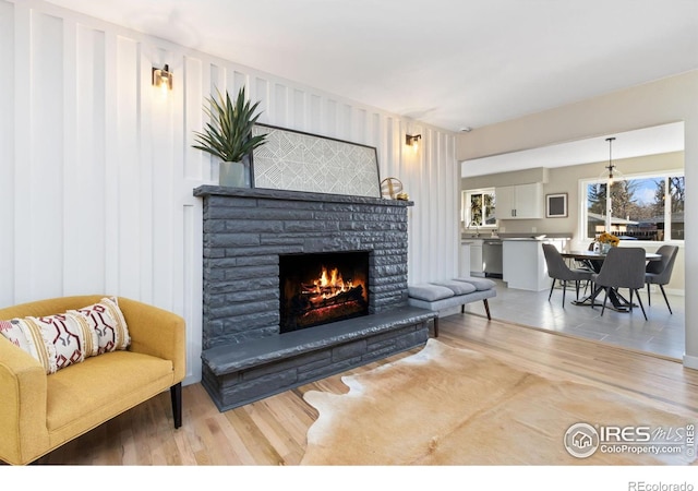 living room featuring a fireplace and light hardwood / wood-style flooring