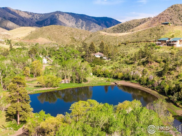 aerial view featuring a water and mountain view