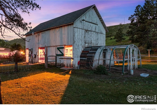 outdoor structure at dusk with a yard