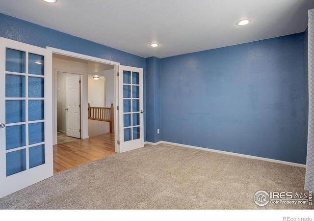 carpeted spare room with french doors