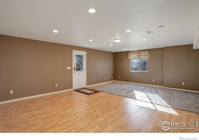 unfurnished room with light wood-type flooring