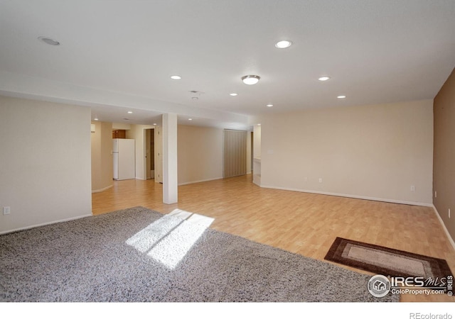 interior space with light wood-type flooring and white fridge