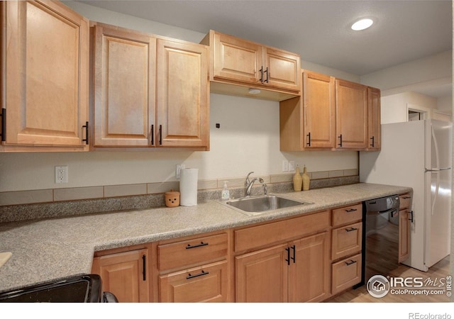 kitchen with white fridge, stove, light brown cabinetry, dishwasher, and sink