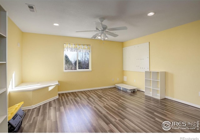 spare room featuring ceiling fan and hardwood / wood-style floors