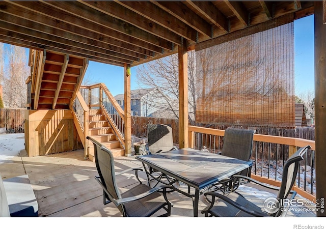 snow covered deck featuring a patio