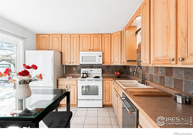 kitchen featuring white appliances, light tile patterned floors, light brown cabinets, and sink