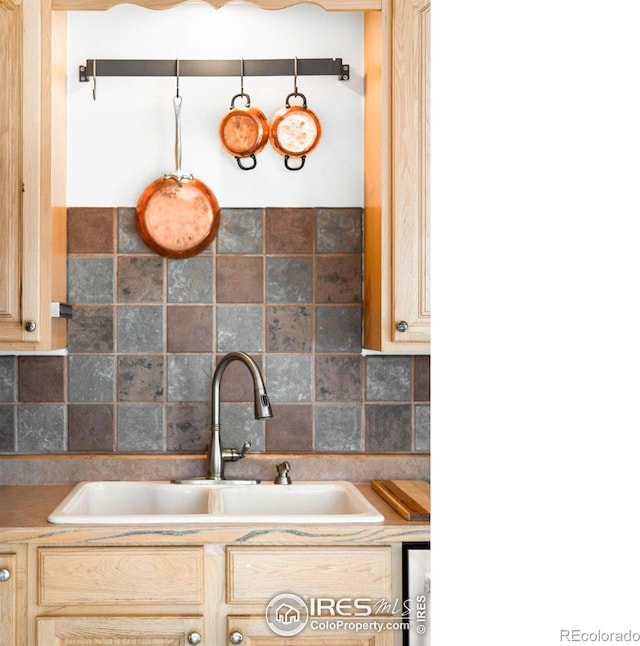 kitchen featuring sink, tasteful backsplash, and light brown cabinets