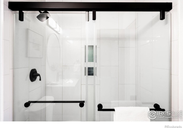 bathroom with a shower with shower door