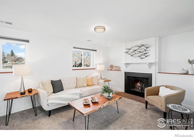 carpeted living room with a fireplace