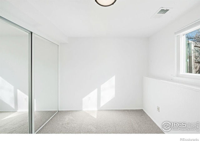 unfurnished bedroom featuring a closet and carpet flooring