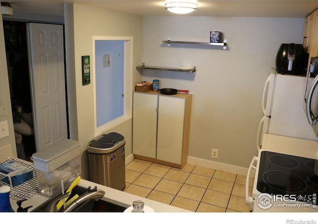 kitchen with range with electric stovetop and light tile patterned floors