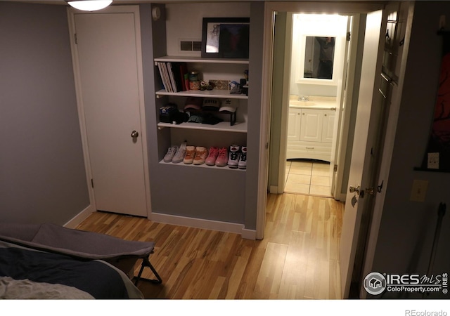 bedroom featuring sink and light hardwood / wood-style flooring