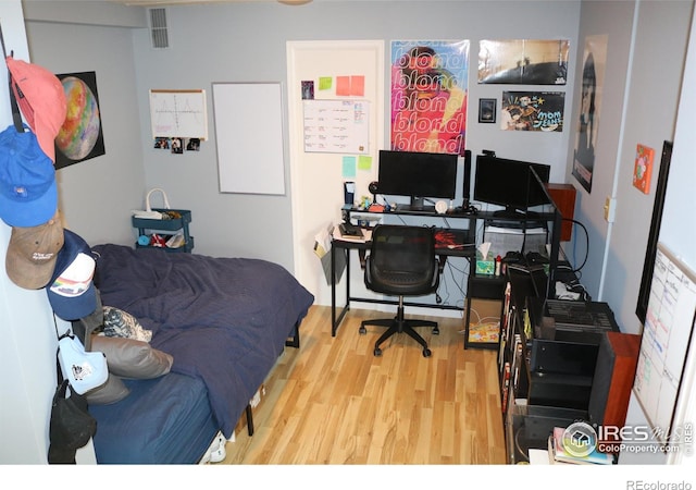 bedroom with wood-type flooring