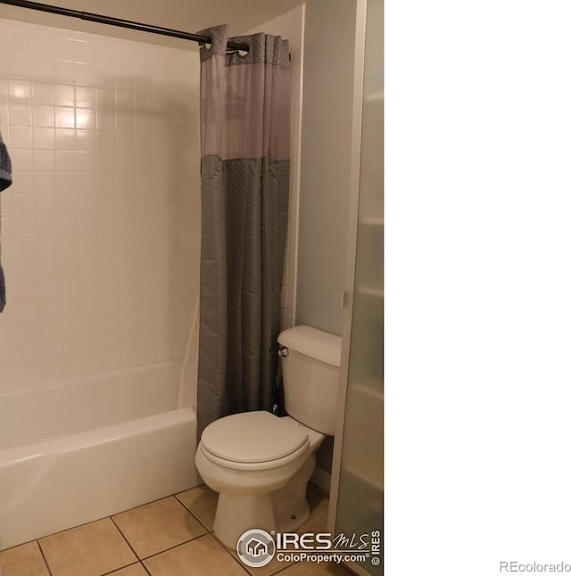 bathroom with shower / tub combo, tile patterned floors, and toilet