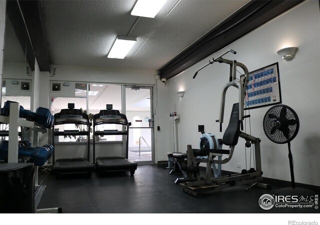 workout area with a textured ceiling and a wealth of natural light