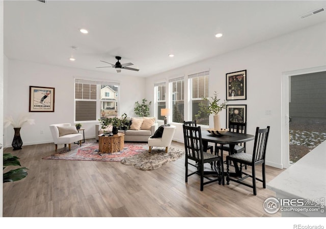 dining area with light hardwood / wood-style floors and ceiling fan