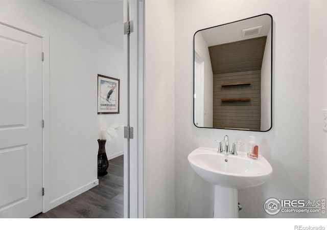 bathroom featuring sink and wood-type flooring