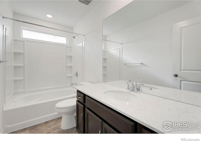 full bathroom featuring shower / bathing tub combination, tile patterned floors, vanity, and toilet