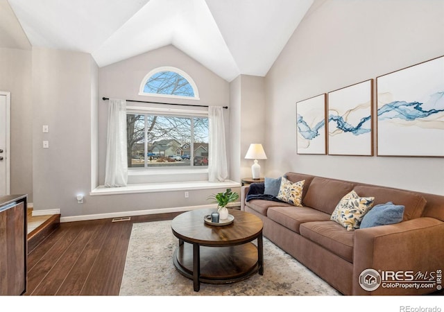 living room featuring vaulted ceiling and dark hardwood / wood-style floors