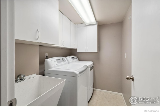 laundry room with sink, cabinets, and washing machine and dryer