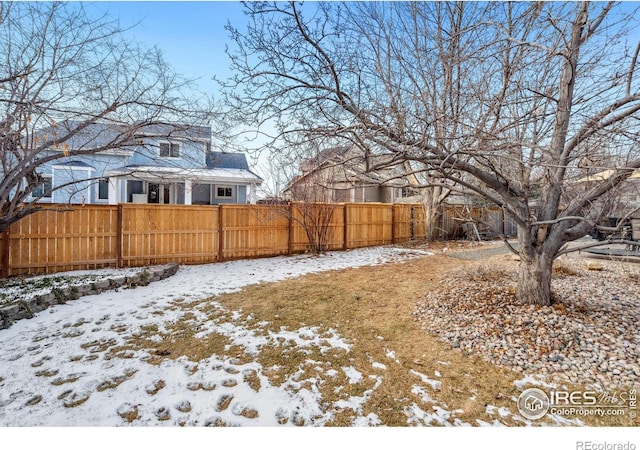 view of yard layered in snow