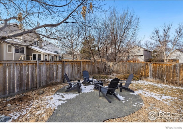 snow covered patio featuring a fire pit