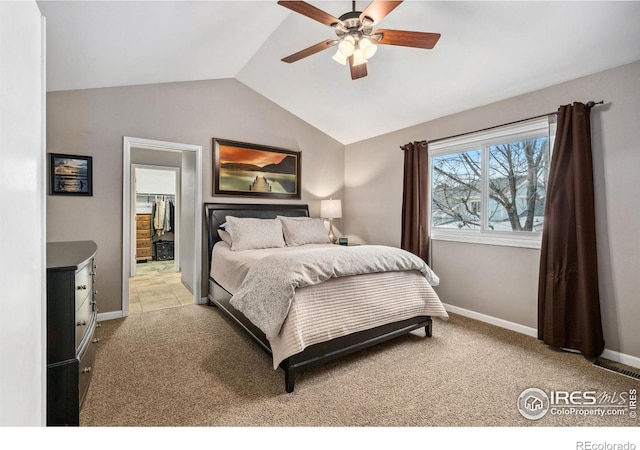 bedroom featuring vaulted ceiling, light colored carpet, and ceiling fan