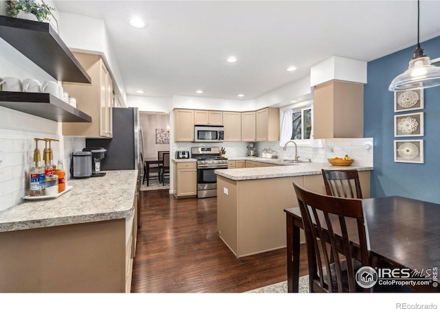 kitchen with tasteful backsplash, stainless steel appliances, kitchen peninsula, and light brown cabinets