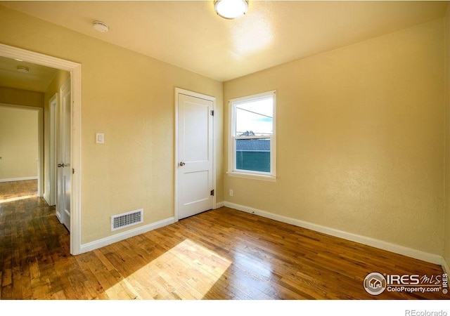 unfurnished bedroom with hardwood / wood-style flooring