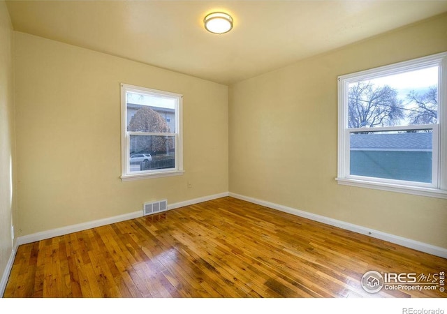 spare room with hardwood / wood-style flooring