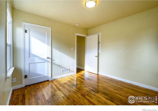 unfurnished bedroom featuring hardwood / wood-style flooring