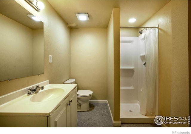 bathroom with vanity, tile patterned flooring, curtained shower, and toilet