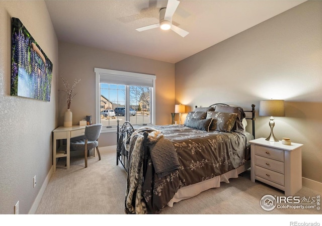 bedroom with ceiling fan and light colored carpet