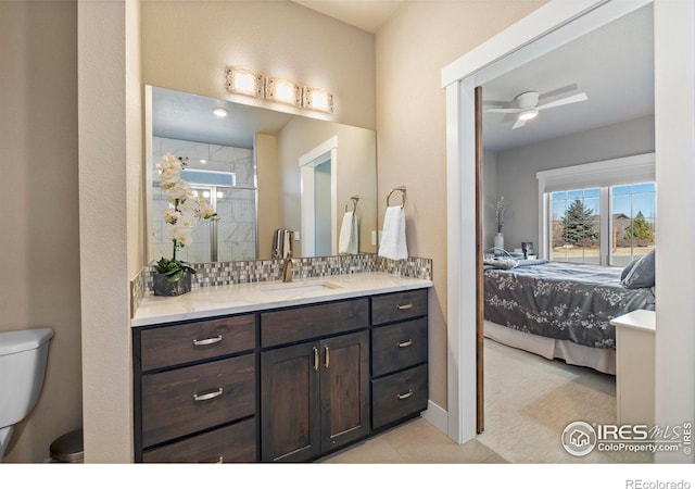 bathroom with ceiling fan, tasteful backsplash, toilet, an enclosed shower, and vanity