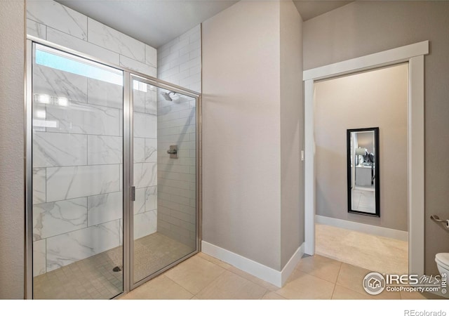 bathroom with toilet, a shower with shower door, and tile patterned floors