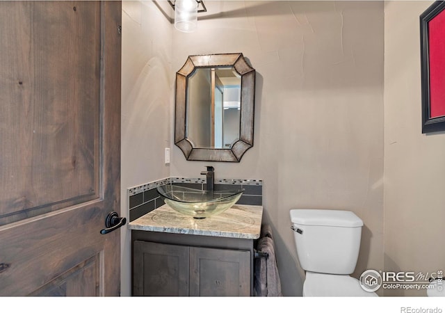 bathroom with toilet and vanity