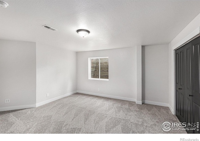 unfurnished bedroom featuring carpet flooring, baseboards, and visible vents