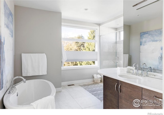 bathroom with tile patterned flooring, shower with separate bathtub, and vanity