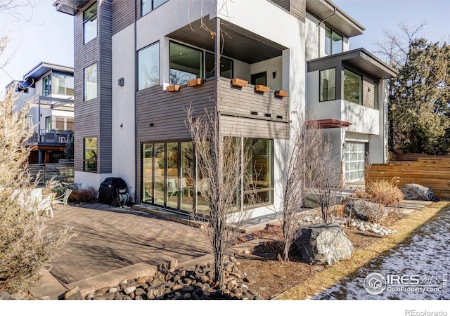 view of side of property featuring a patio