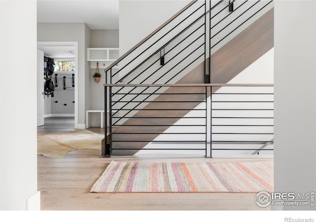 stairway featuring wood-type flooring