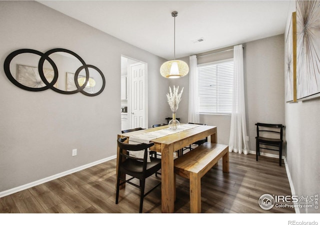 dining area with dark hardwood / wood-style flooring