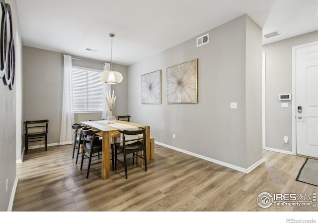 dining space with hardwood / wood-style floors