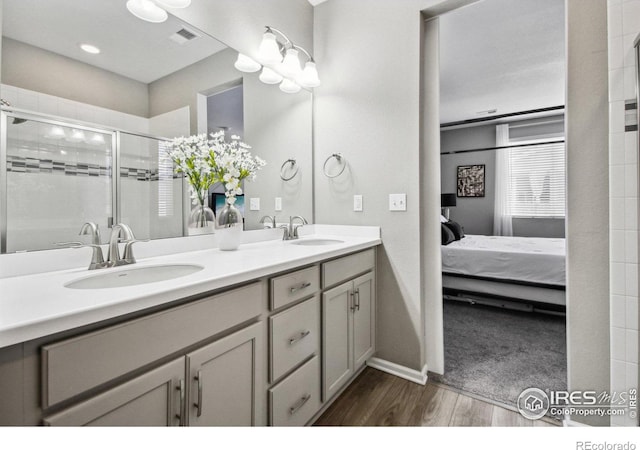 bathroom with vanity, hardwood / wood-style floors, and walk in shower