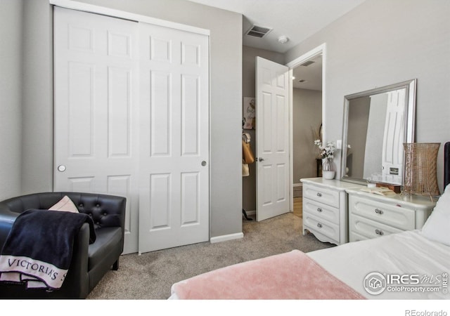 carpeted bedroom featuring a closet